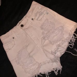 White ripped shorts